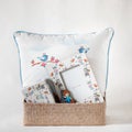 Gift set of a pillow with cute drawings on it and picture frames in a box