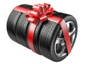 Gift set tyres with a wrapped red ribbon and bow. Royalty Free Stock Photo