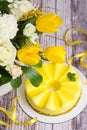 Gift set - yellow mousse cake and a large Spring medley bouquet of beautiful flowers. Valentine`s Day. Happy Mother`s day Royalty Free Stock Photo