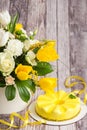 Gift set - yellow mousse cake and a large Spring medley bouquet of beautiful flowers. Valentine`s Day. Happy Mother`s day Royalty Free Stock Photo