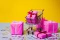 Gift shopping, shopping cart is full of gift boxes. New year`s shopping concept