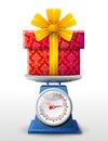 Gift symbol on scale pan Royalty Free Stock Photo