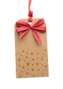 Cardboard gift tag with red bow isolated on white Royalty Free Stock Photo