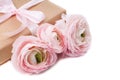 Gift tied with ribbon and pink flowers Royalty Free Stock Photo