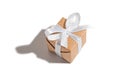 Gift tied with a white ribbon on a white isolated background. Celebration and congratulations holiday concept