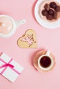 Gift to Valentine's Day, with tea and cupids on a pink background. Top view, film effect