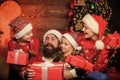 gift to you. cheerful mother love children. santa father at decorated tree. Happy family celebrate new year and Royalty Free Stock Photo