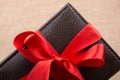 Gift wallet wrapped with red ribbon