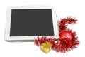 Gift white tablet with Christmas ball, box and red chain Royalty Free Stock Photo