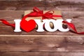 Gift and the words `I love you` on a wooden background . Valentines day red heart. Valentine day card.