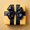 Gift wrap. Black and yellow box with a bow on a plain background Royalty Free Stock Photo