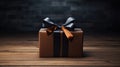 a gift wrapped in dark packaging with a ribbon and bow, positioned on a wooden background, leaving generous empty space