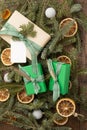 A gift wrapped in plain, green, and brown papers, plaid bow and tag for message Royalty Free Stock Photo