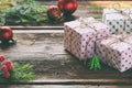 Gift wrapping. Christmas composition with present box, packing paper, festive decoration and fir tree branch. Preparation for holi Royalty Free Stock Photo