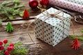 Gift wrapping. Christmas composition with present box, packing paper, festive decoration and fir tree branch. Preparation for holi Royalty Free Stock Photo