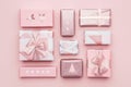 Gift wrapping composition. Beautiful nordic christmas gifts isolated on pastel pink background. Pink colored wrapped gift boxes.