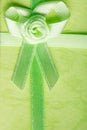 Giftbox closeup. Ribbon with bow on green background Royalty Free Stock Photo