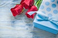 Giftbox scented red roses on wooden board celebrations concept