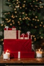 Gifts on the background of a Christmas tree with a bokeh. Royalty Free Stock Photo