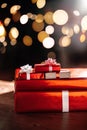 Gifts on the background of a Christmas tree with a bokeh. Royalty Free Stock Photo