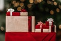 Gifts on the background of a Christmas tree with a bokeh. Royalty Free Stock Photo