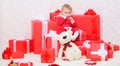 Gifts for child first christmas. Celebrate first christmas. Little baby girl play near pile of gift boxes. Family Royalty Free Stock Photo