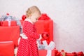 Gifts for child first christmas. Little baby girl play near pile of gift boxes. Family holiday. Celebrate first Royalty Free Stock Photo