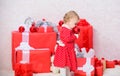 Gifts for child first christmas. Little baby girl play near pile of gift boxes. Family holiday. Christmas activities for Royalty Free Stock Photo