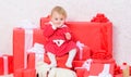 Gifts for child first christmas. Little baby girl play near pile of gift boxes. Family holiday. Things to do with Royalty Free Stock Photo