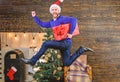 Gifts delivery. Man santa hat hurry to deliver gift on time. Spread happiness and joy. Bearded guy in motion jump Royalty Free Stock Photo