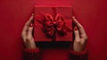 Gifts of Love: Woman\'s Hands Holding Luxury Box with Bow in Top-Down View Royalty Free Stock Photo