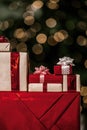 Gifts on the background of a Christmas tree with a bokeh. Royalty Free Stock Photo