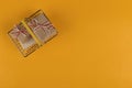 Gifts in a small shopping basket on a yellow background, concept, copy space Royalty Free Stock Photo