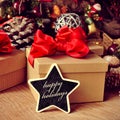 Gifts and text happy holidays in a star-shaped chalkboard Royalty Free Stock Photo