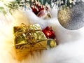Under the Christmas tree on the faux fur is a gift in yellow packaging. Christmas and New Year. Royalty Free Stock Photo
