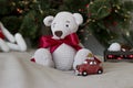 Gifts under the tree for Christmas day. Very cute hand crochet teddy bear with red bow. Christmas background Royalty Free Stock Photo