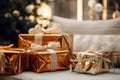 gifts wrapped in gold foil sitting on a couch in front of a christmas tree