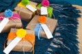 Gifts wrapped in kraft paper lie on a knitted rug. Royalty Free Stock Photo