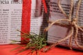 Gifts wrapped in old newspaper on red background