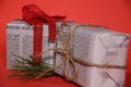 Gifts wrapped in old newspaper on red background