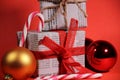 Gifts wrapped in old newspaper on red background