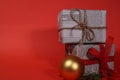 Gifts wrapped in old newspaper on red background