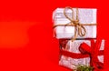 Gifts wrapped in old newspaper on red background