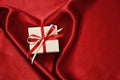 Gify box on red satin Royalty Free Stock Photo