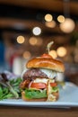 gigantic burger at american restaurant piled high with egg, tomato, cheese, onion, & lettuce on brioche