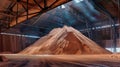 A gigantic pile of sand carefully stacked in a warehouse dedicated to potash fertilizers, ready for mining and processing