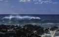 Gigantic Turquoise Swells ready to crash into black lava cliffs on a blue sky summer day in Sicily Royalty Free Stock Photo