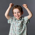 Giggling preschool child enjoying his winning success Royalty Free Stock Photo