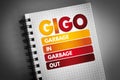 GIGO - Garbage In Garbage Out acronym on notepad, technology concept background