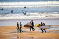 A pack of surfers enjoying their time at San Lorenzo beach during a sunny Easter morning. Royalty Free Stock Photo